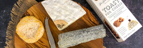 Cheese with crackers on a wooden board