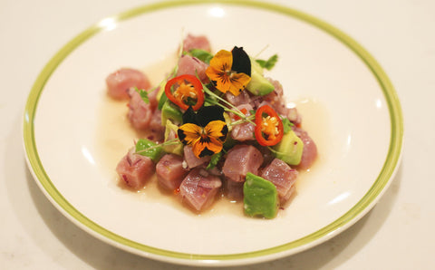 Spicy tuna and avocado ceviche with lime, red chilli, fresh coriander and edible flowers