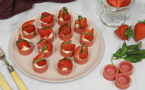 Mini strawberry and basil tartlets filled with vanilla custard and fresh strawberries