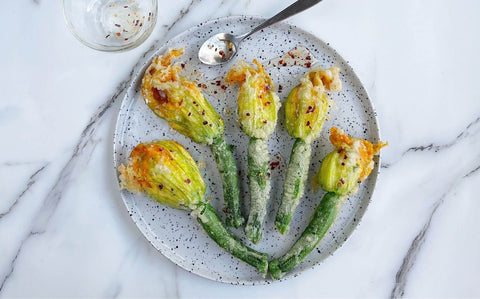 Golden fried stuffed courgette flowers with ricotta, herbs and chilli honey