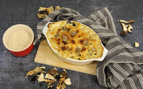 Baked truffle mac and cheese with creamy white truffle sauce, cheddar and wild mushrooms