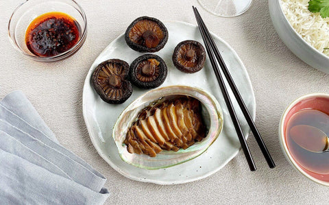 Braised abalone with aged soy served in its shell