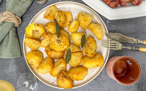 Crispy roast potatoes with black truffle dust and sage