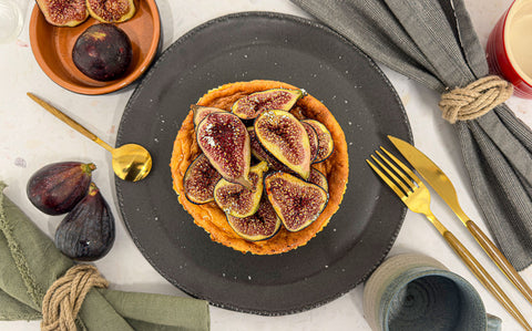 Bright red figs brûléed and served on top of a cheese cake