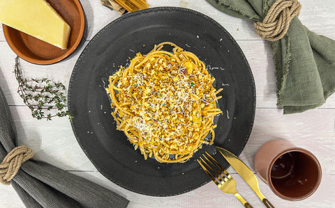 Golden panko breadcrumbs scattered over a yellow pasta sauce