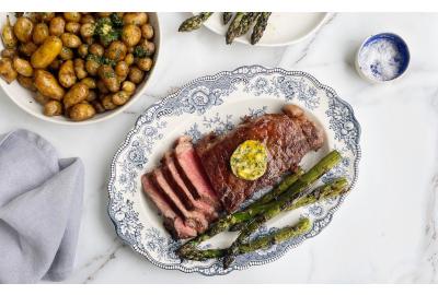 NY Striploin steak sliced with asparagus and jersey royal potatoes