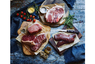 Various cuts of raw meat on baking paper 